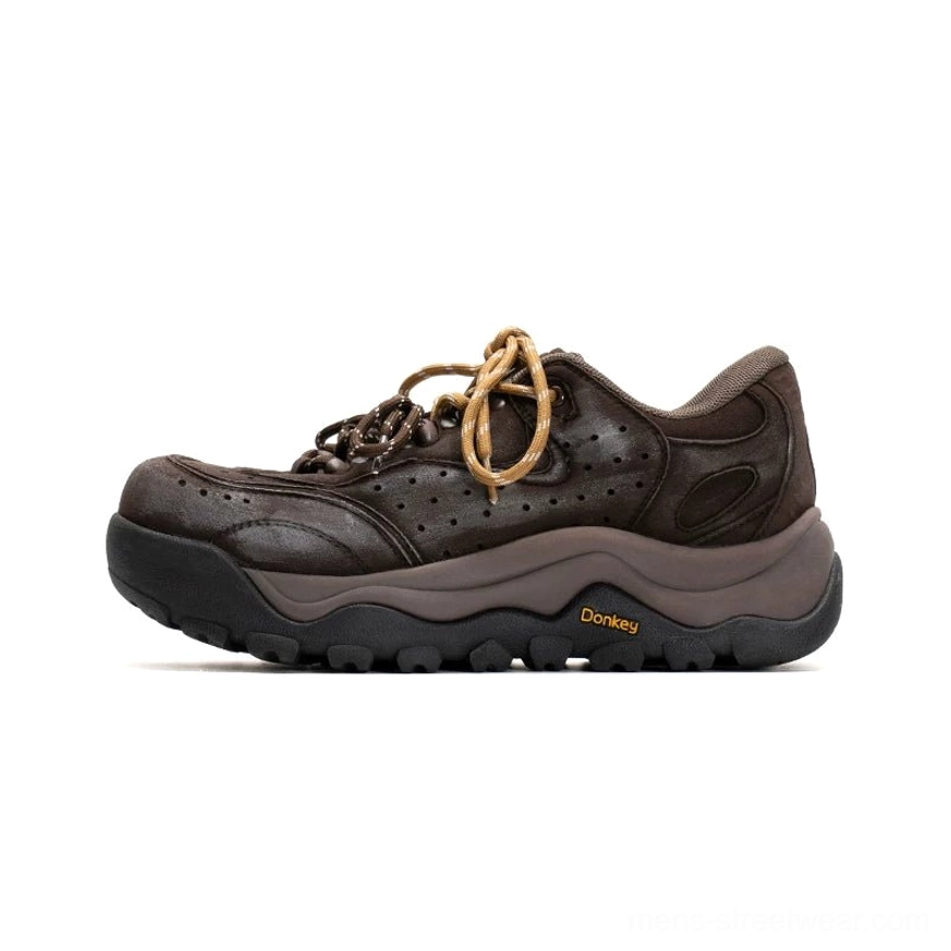 Dark brown Terrain Crest chunky trail sneakers in side profile with full suede-like upper, tan laces, layered panels, and matching rugged outsole
