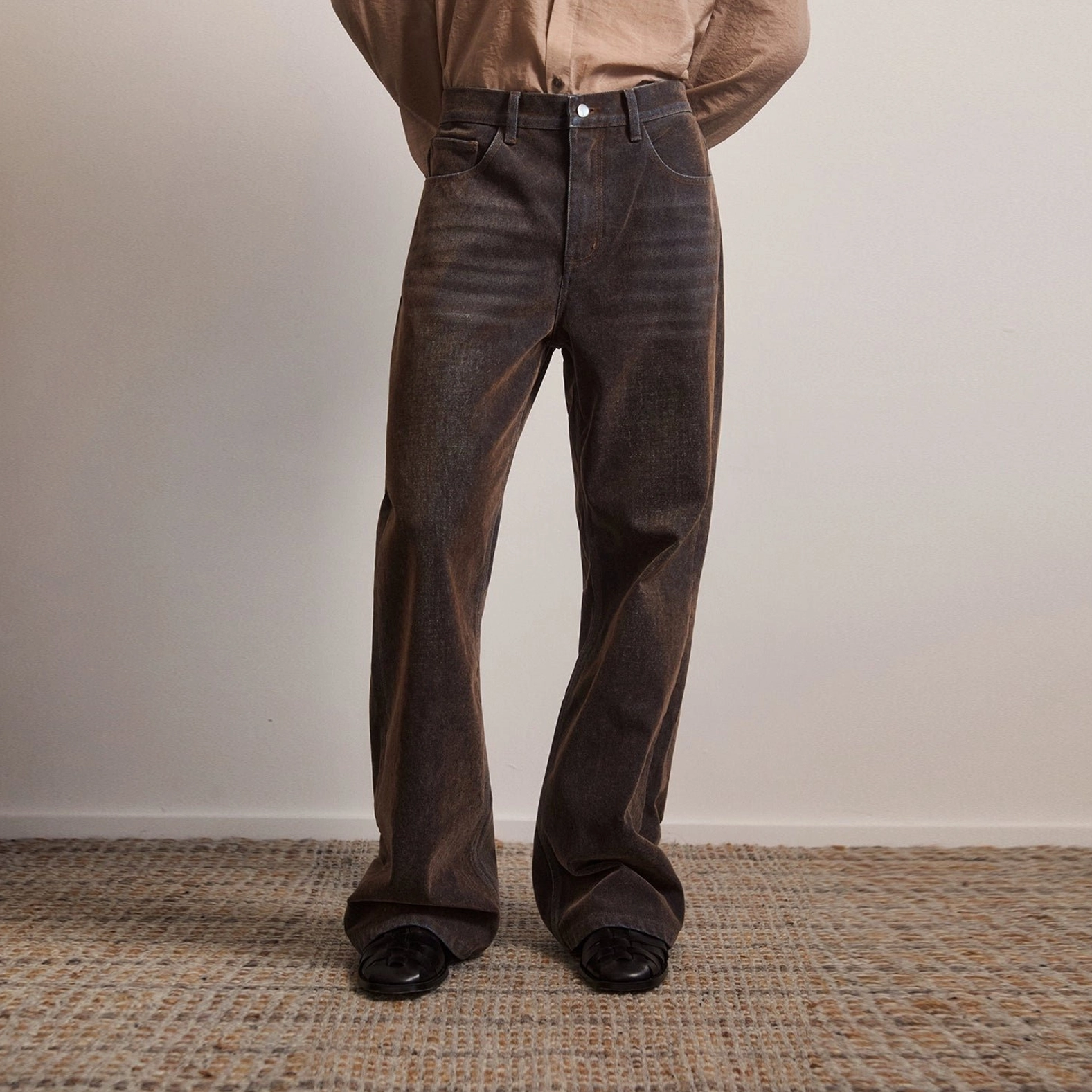 Dark brown vintage flare jeans front detail view showing waistband front fly and tailored wide flared leg
