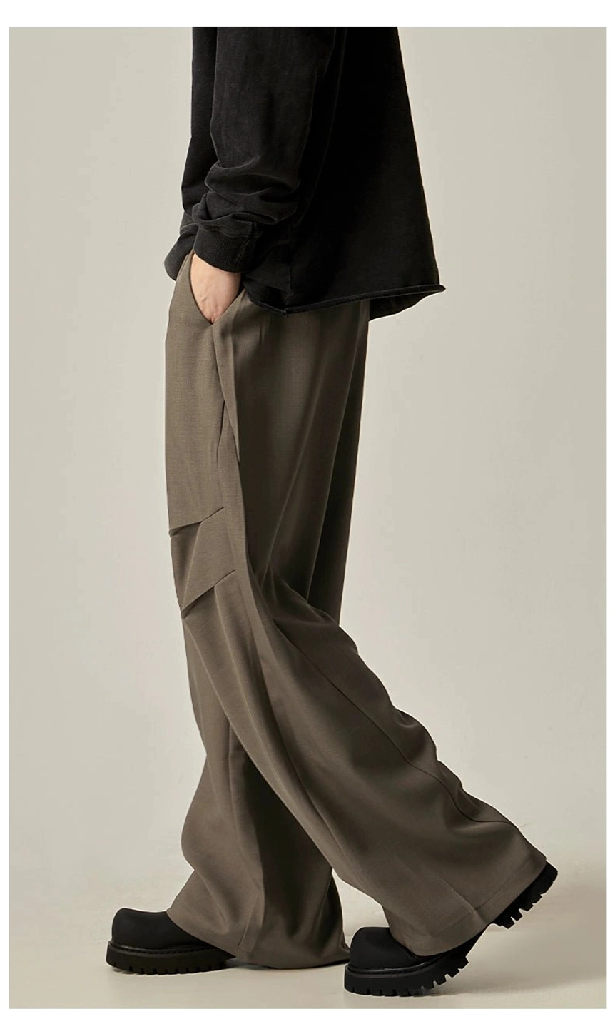 Dark camel taupe wide-leg cargo trousers shown from the side with relaxed fit, fluid fabric, and practical utility pockets