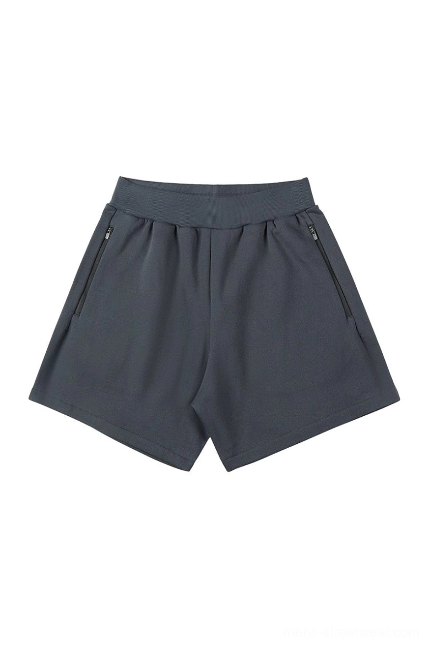 Dark charcoal gray relaxed sweat shorts with secure side zip pockets, above-knee length, and minimalist Korean fashion design
