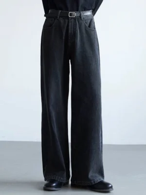 Dark charcoal washed wide-leg denim jeans in a relaxed full-length silhouette, styled with a black top for minimalist East Asian streetwear