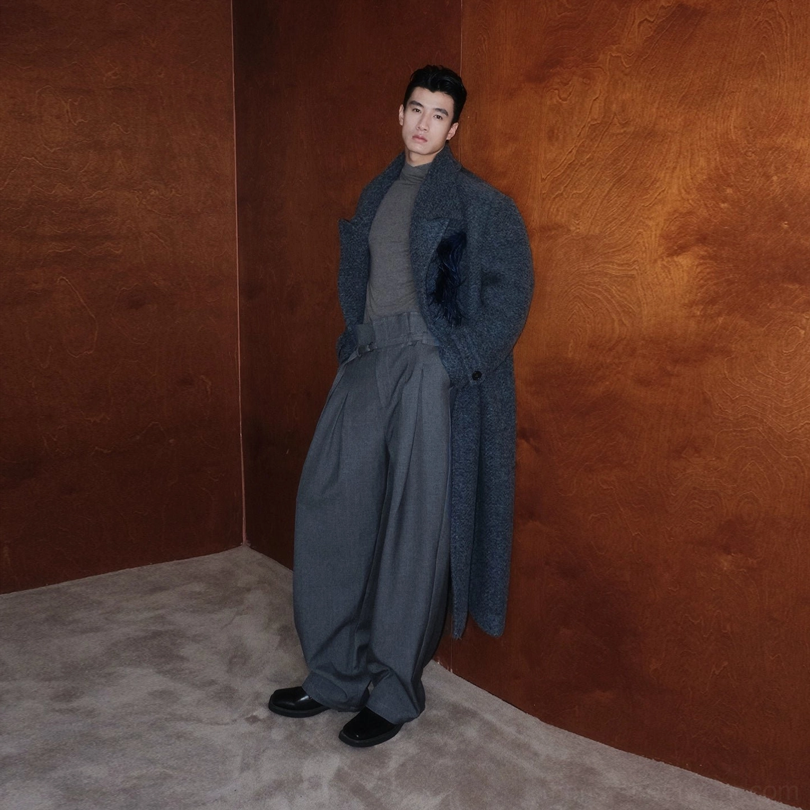 Men's dark gray oversized bouclé wool double-breasted long overcoat with feather-inspired lapel brooch and wide-leg tailored trousers