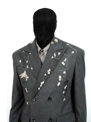 Front close-up of dark gray embroidered double-breasted streetwear suit jacket with ivory bird and floral embroidery on the lapels and shoulders