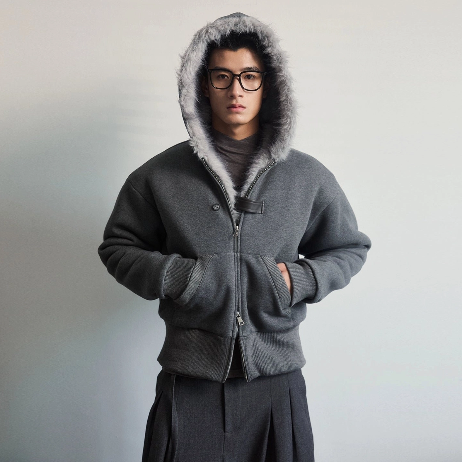 Mens dark gray faux fur lined hood zip jacket with hood worn up and front hand pockets