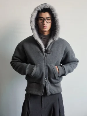 Dark gray faux fur lined hood zip jacket front view worn by male model in minimalist studio