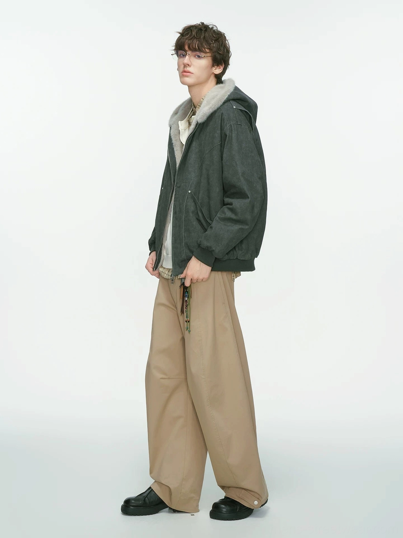 Dark gray hooded bomber jacket with plush faux-shearling hood lining and ribbed hem side profile