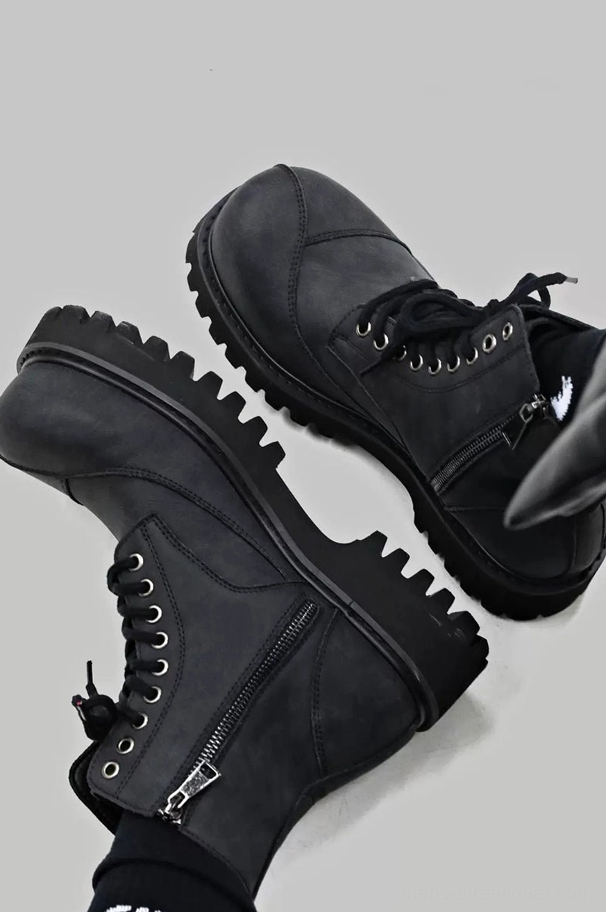 Top close-up of dark gray frosted suede combat boot showing textured upper, metal lace eyelets and structured toe