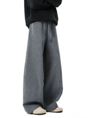 Front view of dark gray heather wide-leg sweatpants featuring an elastic drawstring waistband, relaxed drape, and long streetwear silhouette