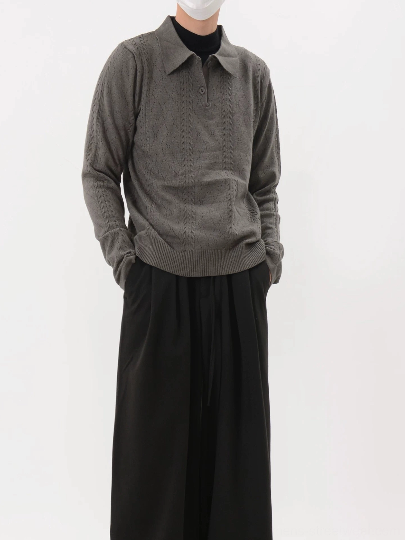Dark gray long sleeve cable knit polo sweater featuring a classic collar, button placket, and dimensional knit texture