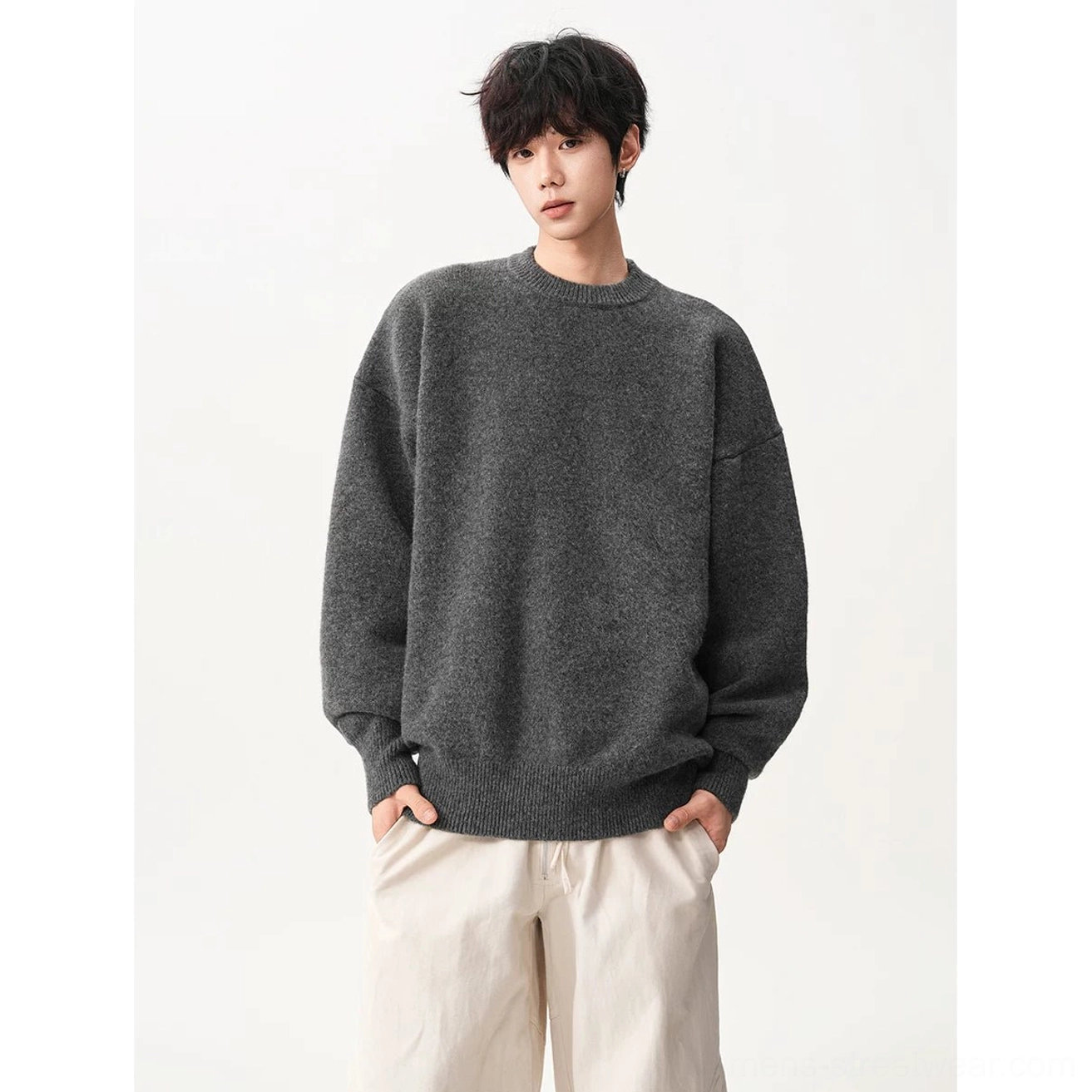 Dark gray oversized crew neck knit sweater product image with softly textured fabric, ribbed cuffs, ribbed hem, and relaxed streetwear styling
