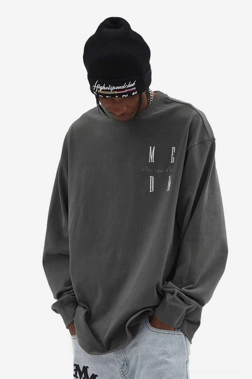 Dark gray oversized MCDM letter graphic long sleeve T-shirt styled with light wash jeans for a relaxed Seoul streetwear outfit