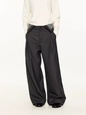 Dark gray plaid waist detail wide-leg trousers styled with a white long-sleeve top in a full front streetwear outfit
