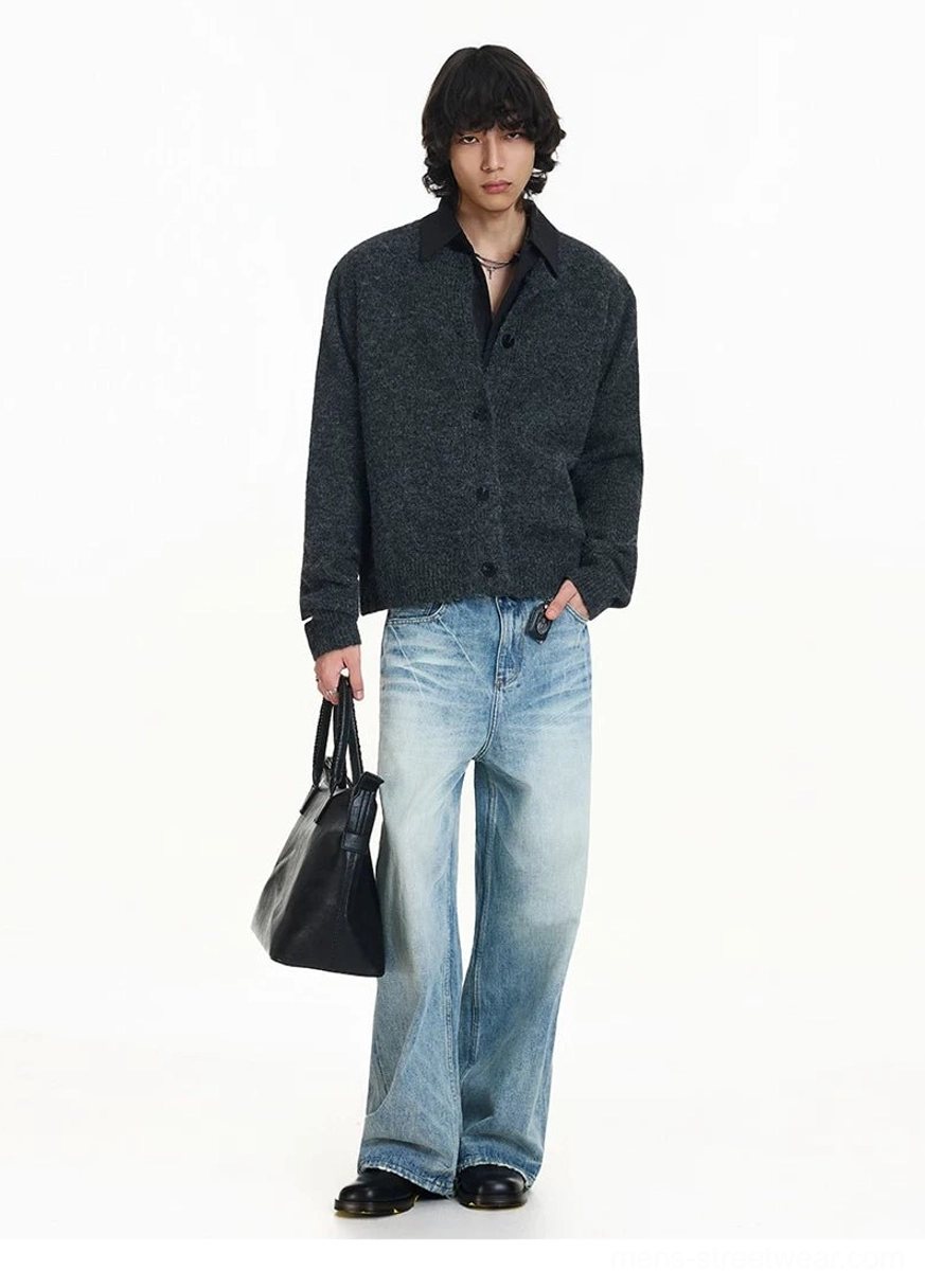 Dark gray polo collar knit cardigan shown in a three-quarter view with black leather tote and casual city outfit