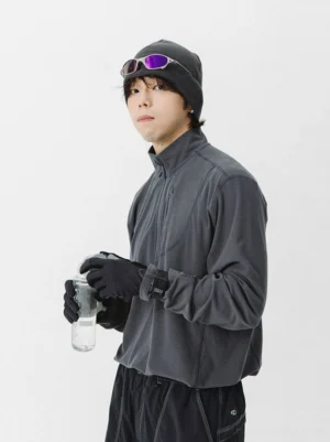 Dark gray quarter zip fleece pullover styled with black beanie gloves dark pants and water bottle for gorpcore streetwear