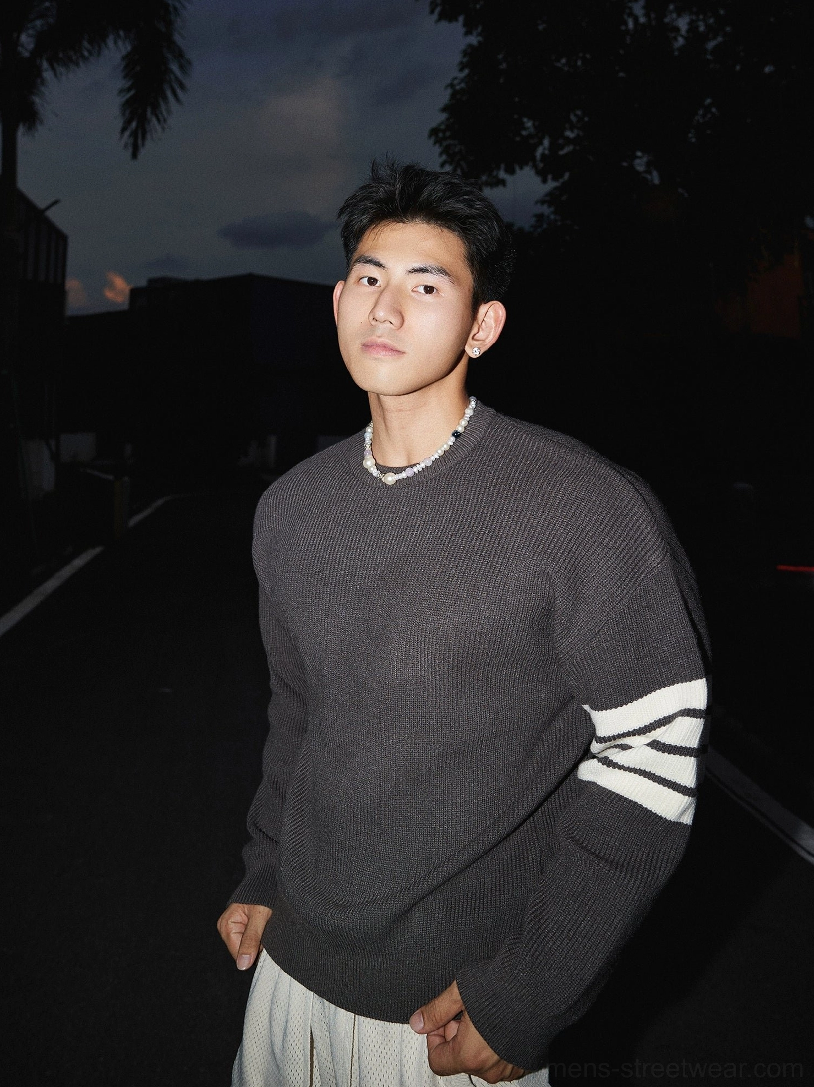Dark gray Korean streetwear crewneck striped sleeve sweater with white triple stripe accents, ribbed knit material, and relaxed fit