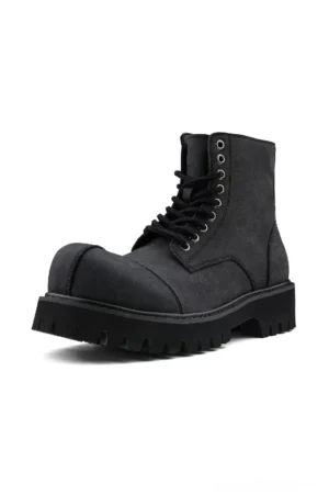 Side view of dark gray suede combat boot featuring metal eyelets, hidden side zipper and thick lug outsole