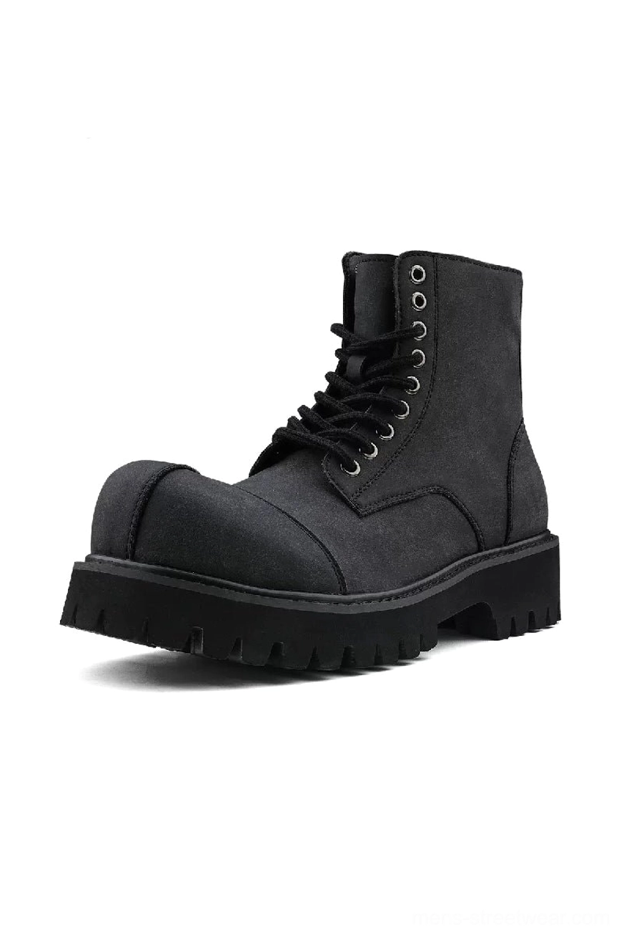 Side view of dark gray suede combat boot featuring metal eyelets, hidden side zipper and thick lug outsole