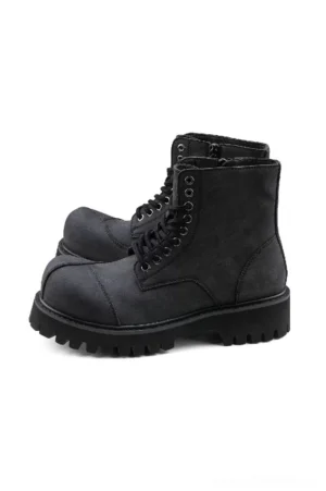 Dark gray suede combat boots with lace-up front, reinforced round toe and chunky deep lug sole on white studio background