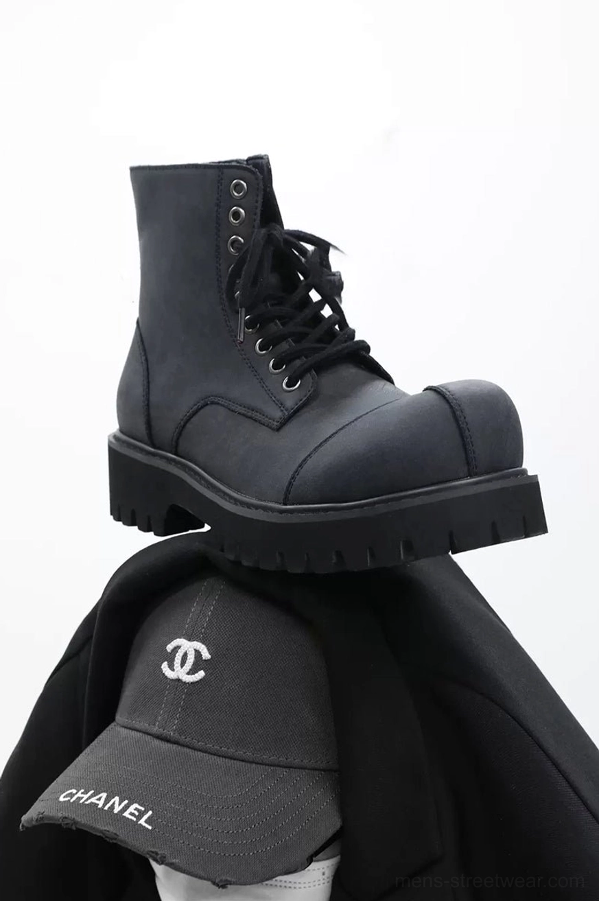 Overhead view of dark gray suede combat boot pair with side zippers, lace-up closure and chunky lug soles