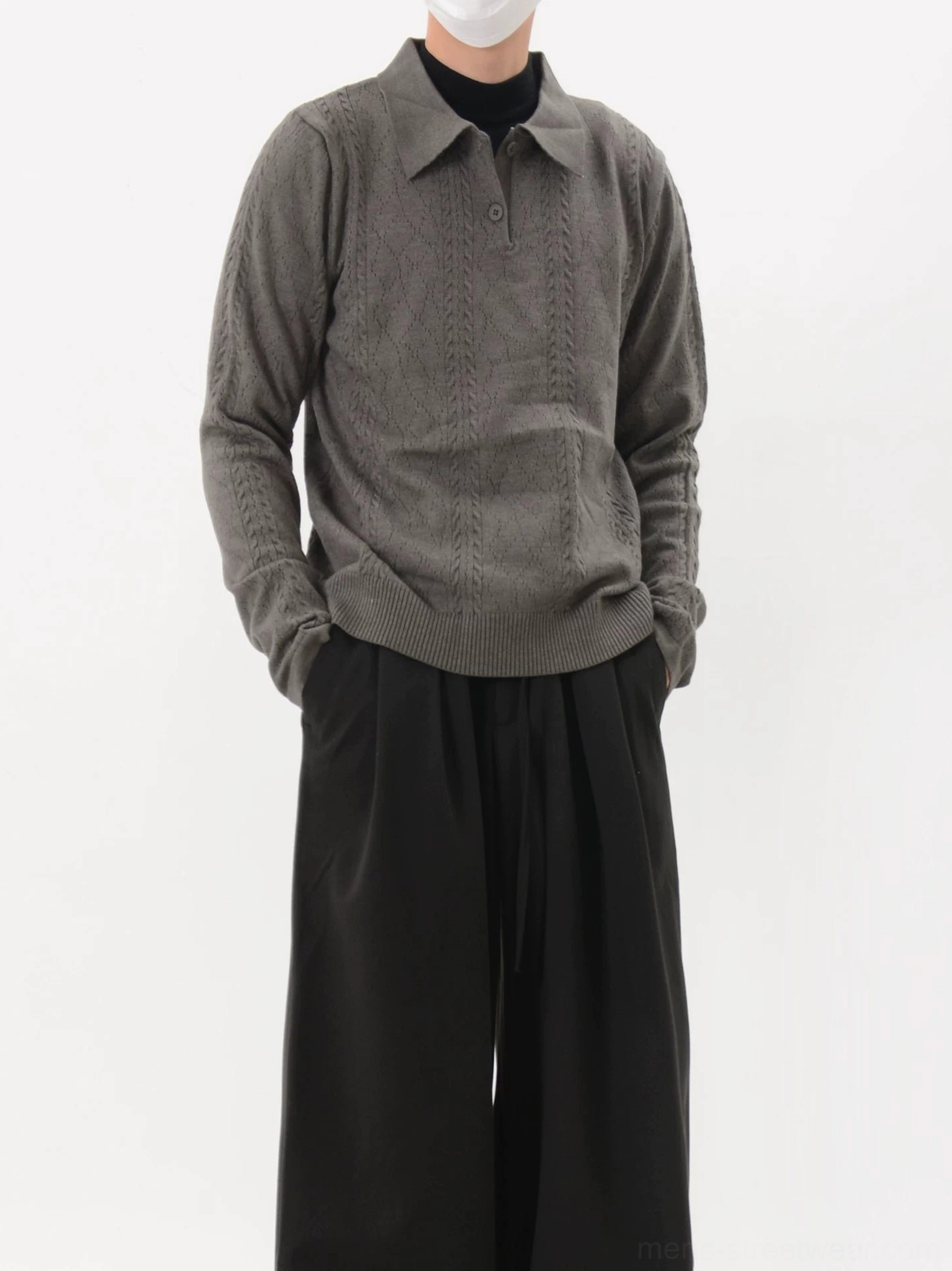 Dark gray textured cable knit polo sweater worn with wide-leg black trousers in a minimalist Seoul-inspired streetwear outfit