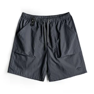 Dark gray water-repellent Taslon cargo shorts with straight leg fit, elastic drawstring waistband, large utility flap pockets, technical waist fastening, and lower hem detail