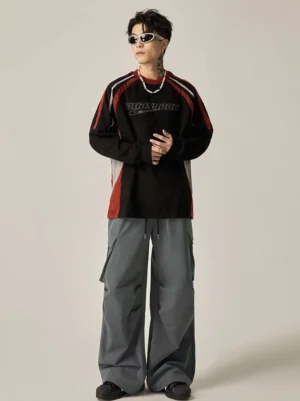 Dark gray wide leg cargo pants styled with a color-block racing sweatshirt, featuring flap cargo pockets and an oversized Korean streetwear silhouette