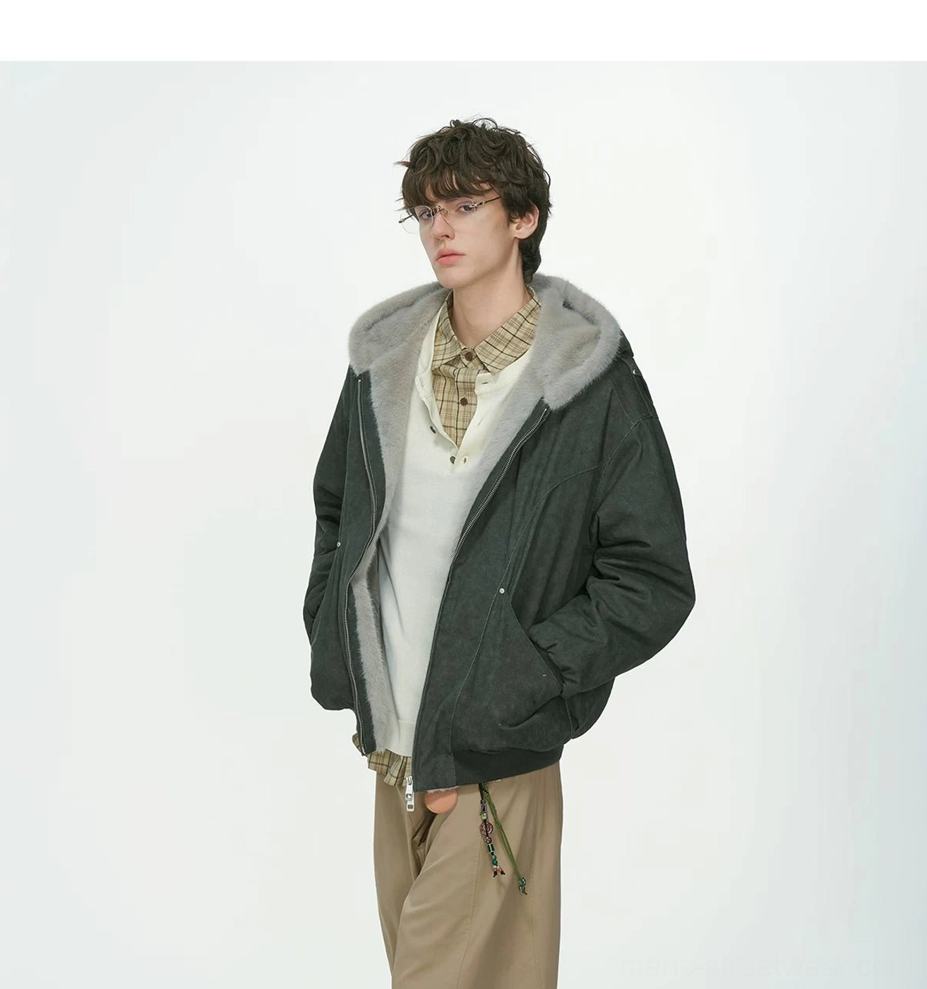 Dark gray winter streetwear hooded bomber jacket with textured shell and plush hood lining three-quarter view
