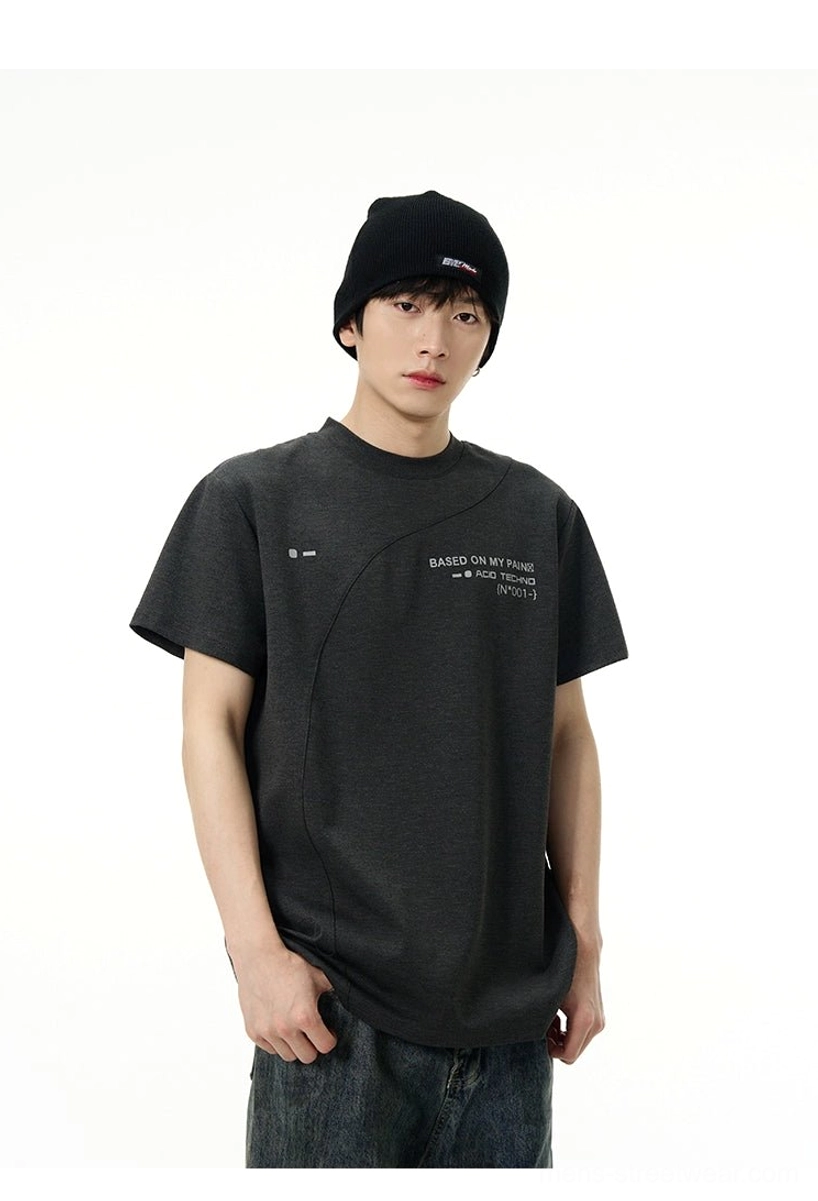 Dark grey Korean streetwear graphic tee with chest print, diagonal construction seam, crew neck, and relaxed silhouette