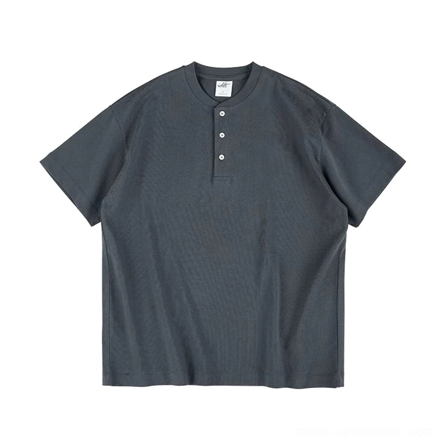 Dark grey heather cotton Henley T-shirt front view with relaxed boxy fit and minimalist three-button neckline