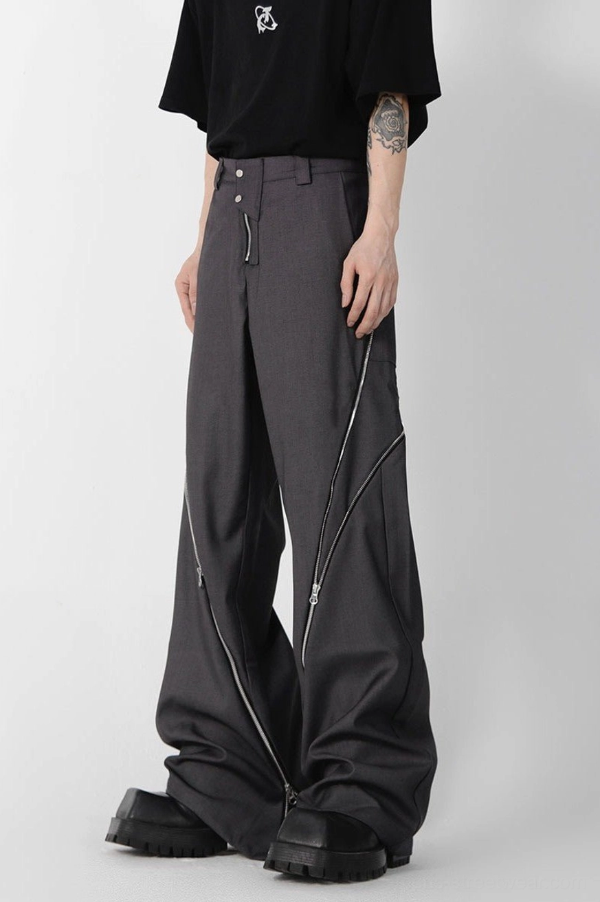 Dark grey high-waisted zipper slit trousers shown from a three-quarter angle with wide legs, outer-leg zipper details, and chunky black platform boots
