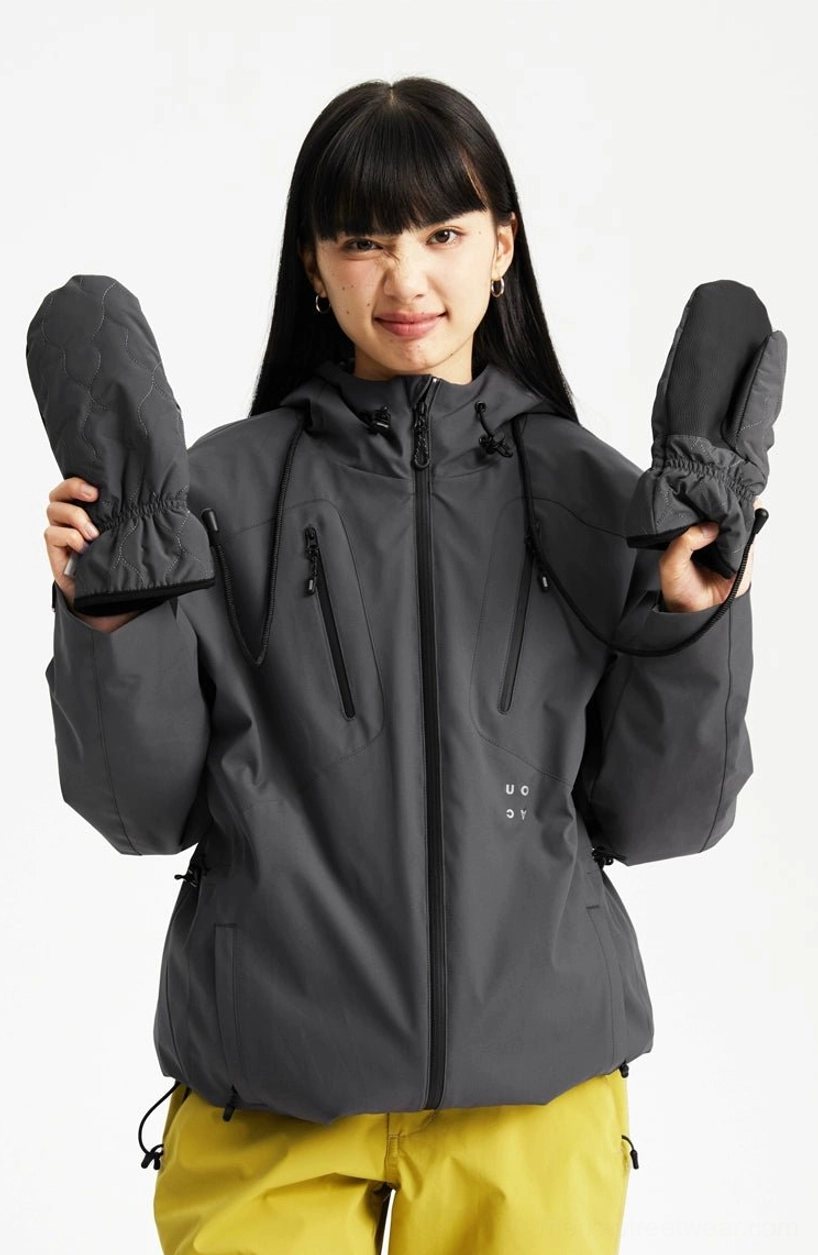 Dark grey hooded outdoor streetwear jacket styled with yellow trousers, featuring a front zipper and multiple zippered pockets