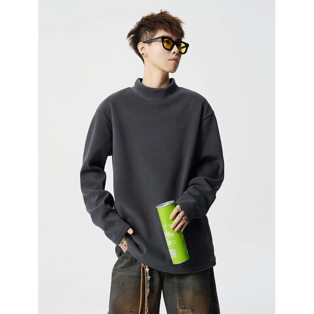 Dark grey mock neck fleece streetwear top shown in three quarter view with relaxed boxy proportions