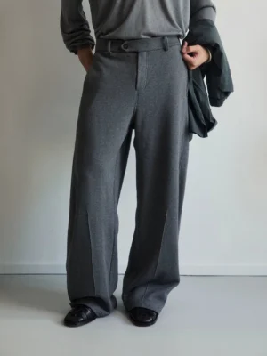 Dark grey soft tailored wide-leg cotton jersey trousers front close-up styled with black leather loafers and a grey top