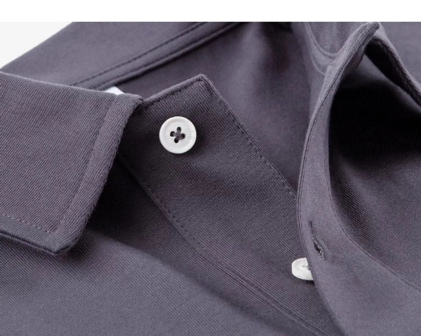 Close up of dark grey technical polo collar with four hole resin buttons, hidden button fastening, and neat placket stitching
