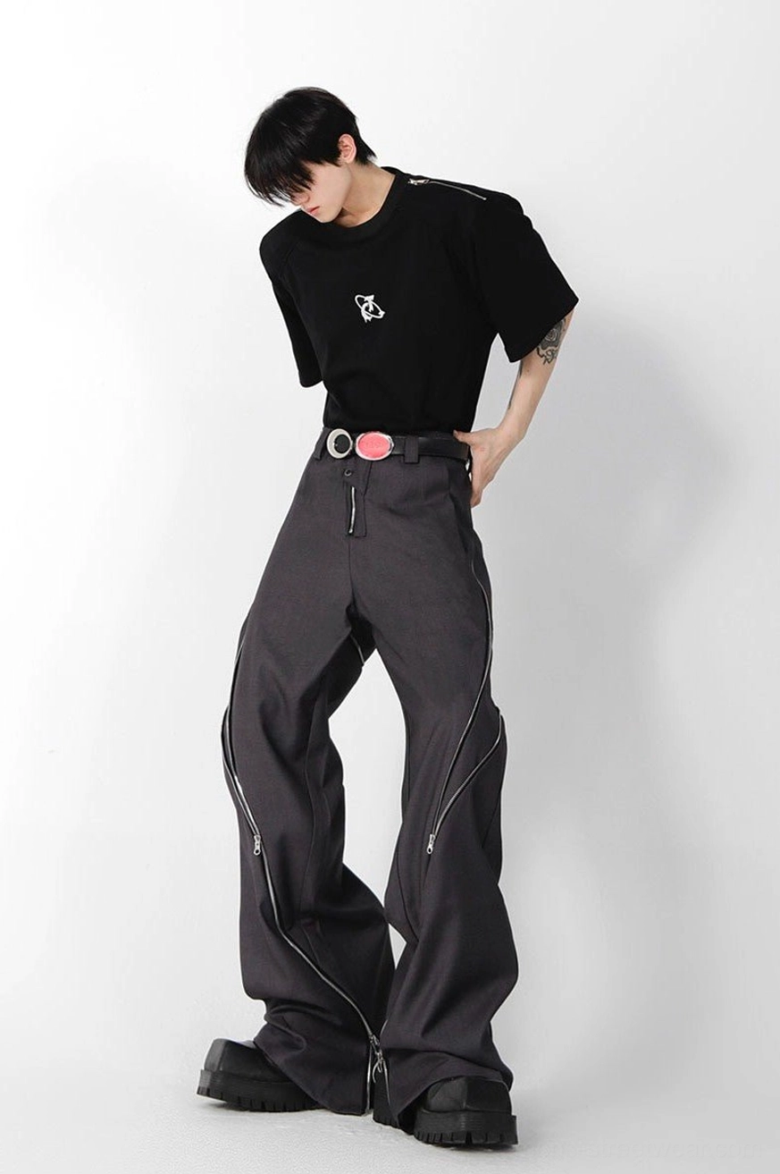 Rear side view of dark grey wide leg zipper trousers featuring outer-leg zipper lines, a dual-buckle waist belt detail, and avant-garde streetwear styling