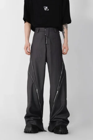 Dark grey zipper slit wide leg trousers shown from the front with a high waist, oversized fit, decorative side zippers, and contemporary Korean streetwear styling