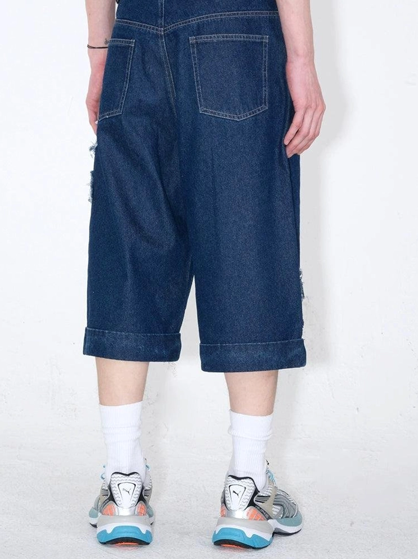 Dark indigo cropped denim culottes with star appliqués and relaxed wide-leg streetwear proportions for everyday styling