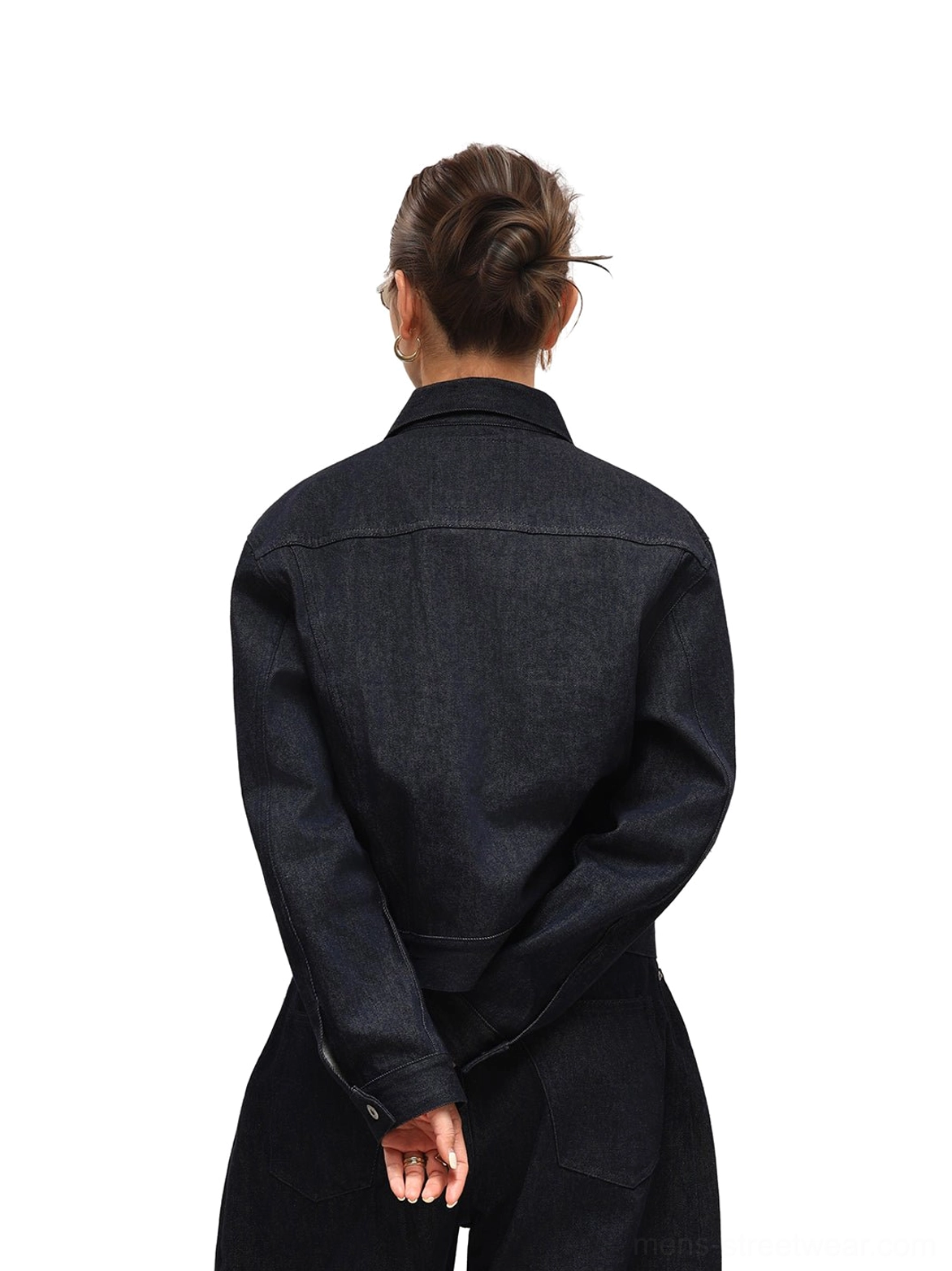 Back model view of dark indigo cropped denim trucker jacket with a clean waist-length silhouette