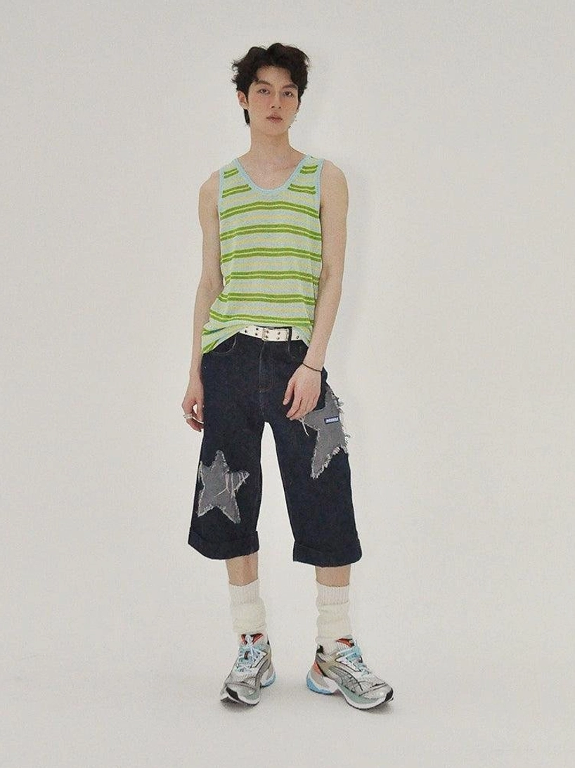 Dark indigo cropped wide-leg denim culottes with frayed star appliqués presented as a contemporary East Asian streetwear essential