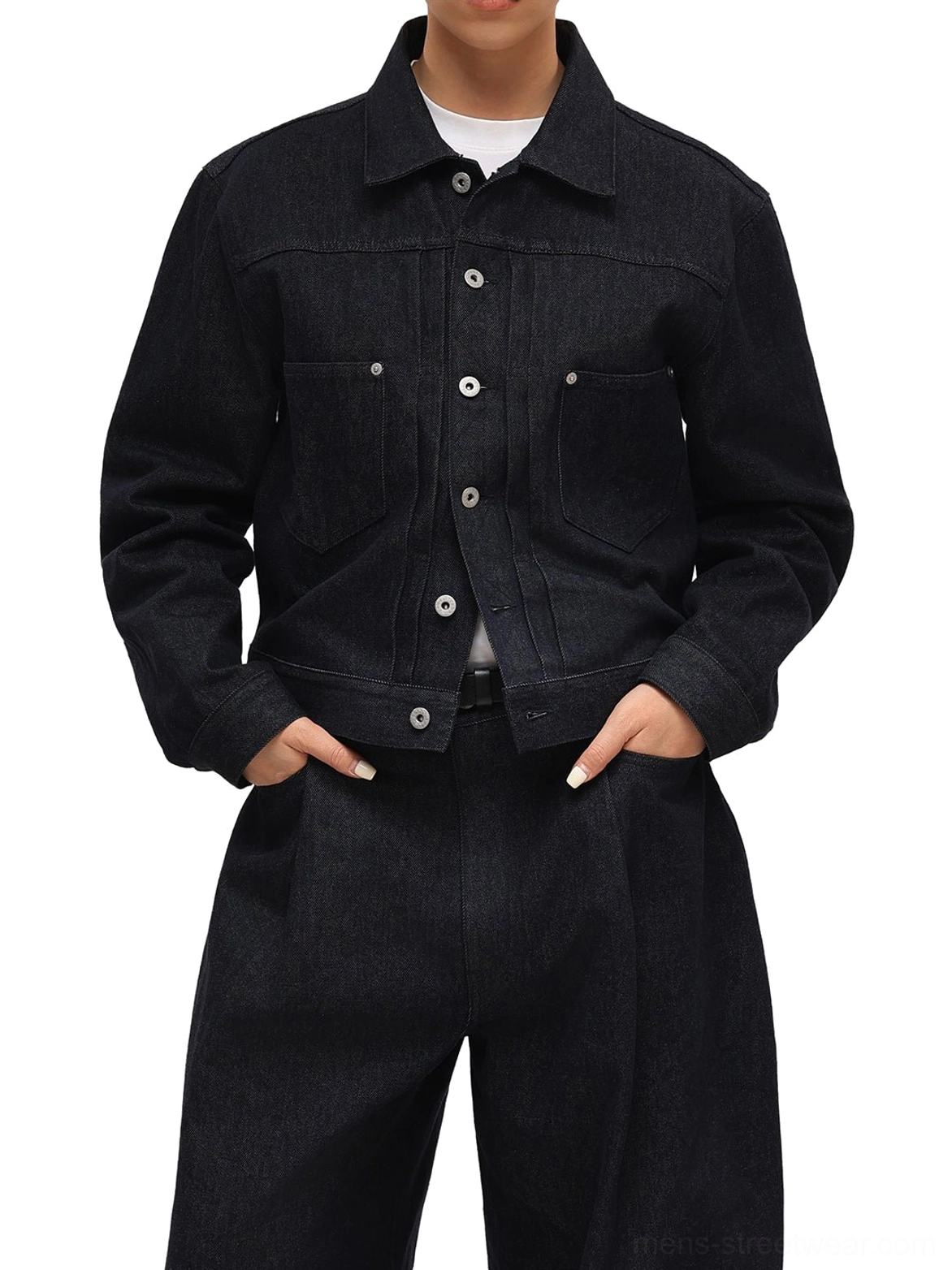 Front model view of dark indigo non-fade cropped denim jacket styled open over a white top