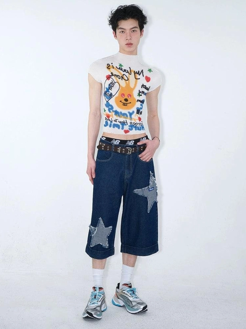 Full front view of dark indigo star appliqué denim culottes styled with a white cropped graphic tee in contemporary streetwear fashion