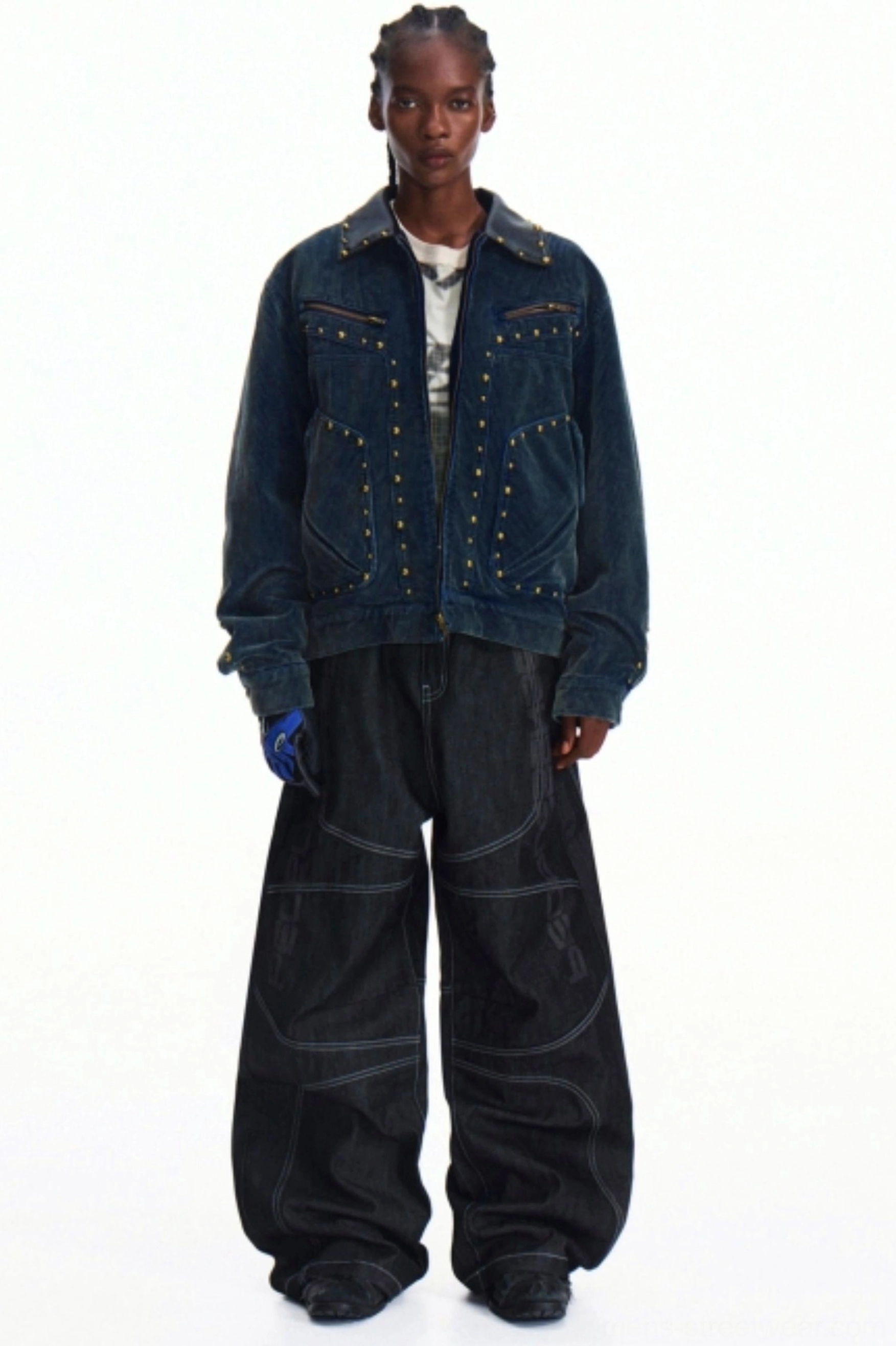 Styled dark indigo wide-leg denim pants worn with a studded denim jacket in a layered contemporary streetwear outfit