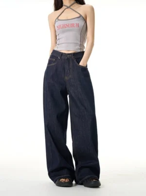 Rear three-quarter view of dark blue wide-leg streetwear jeans showing classic five-pocket denim construction