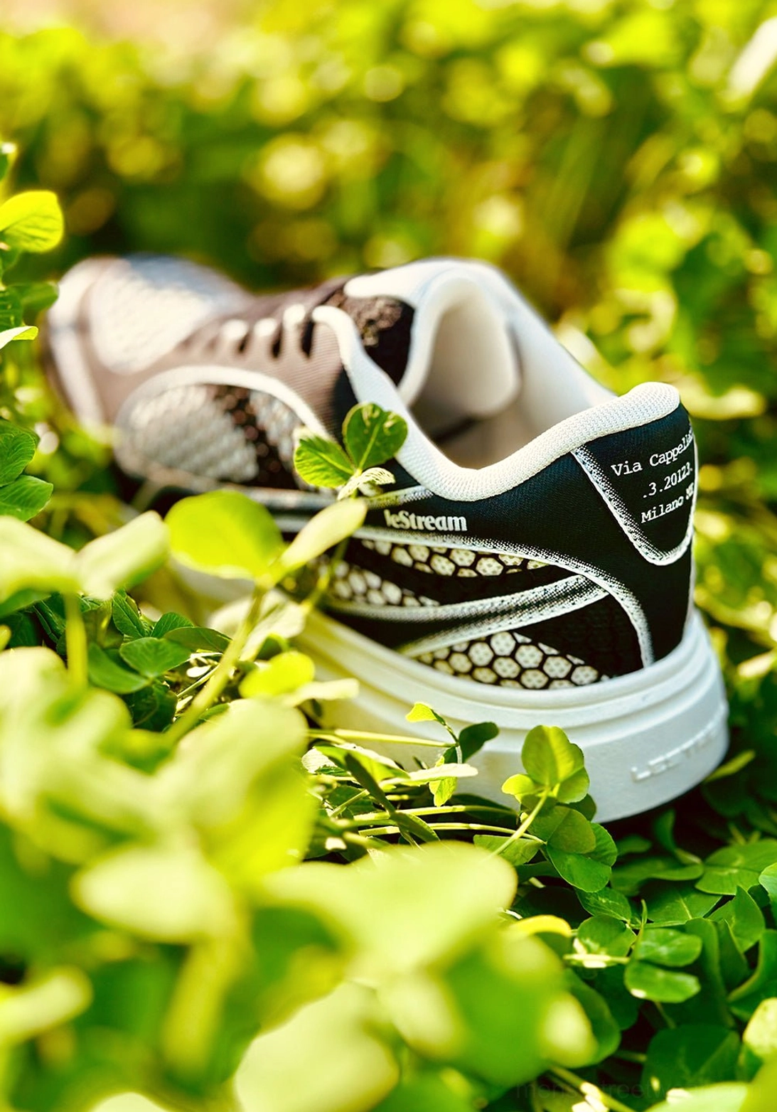 Rear side view of dark-toned mesh platform derby sneakers with white trim, heel branding detail, and elevated white rubber outsole