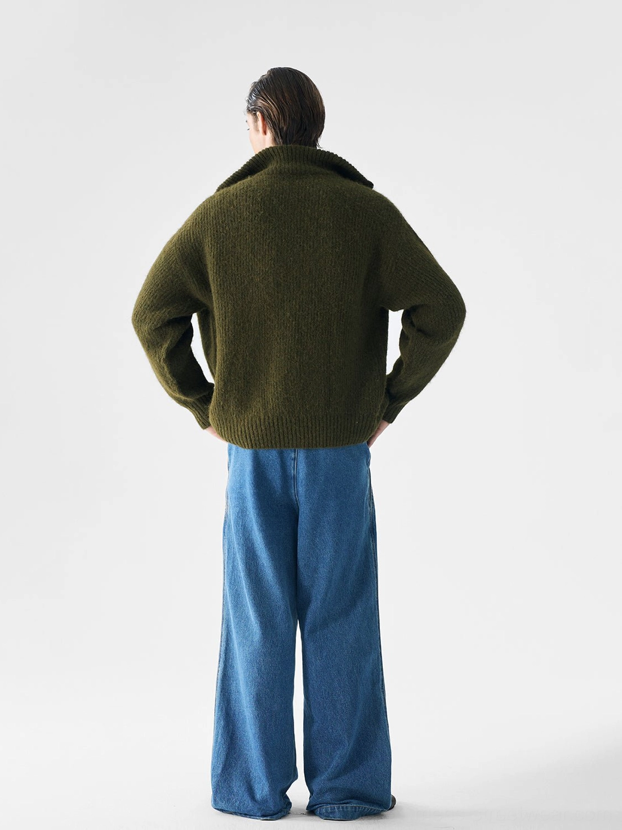 Back view of dark olive green relaxed ribbed full-zip knit sweater for men with boxy silhouette and high collar