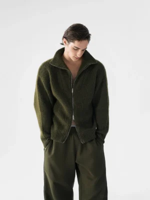 Dark olive green relaxed ribbed two-way zip knit sweater for men shown in front three-quarter view with high fold-down collar