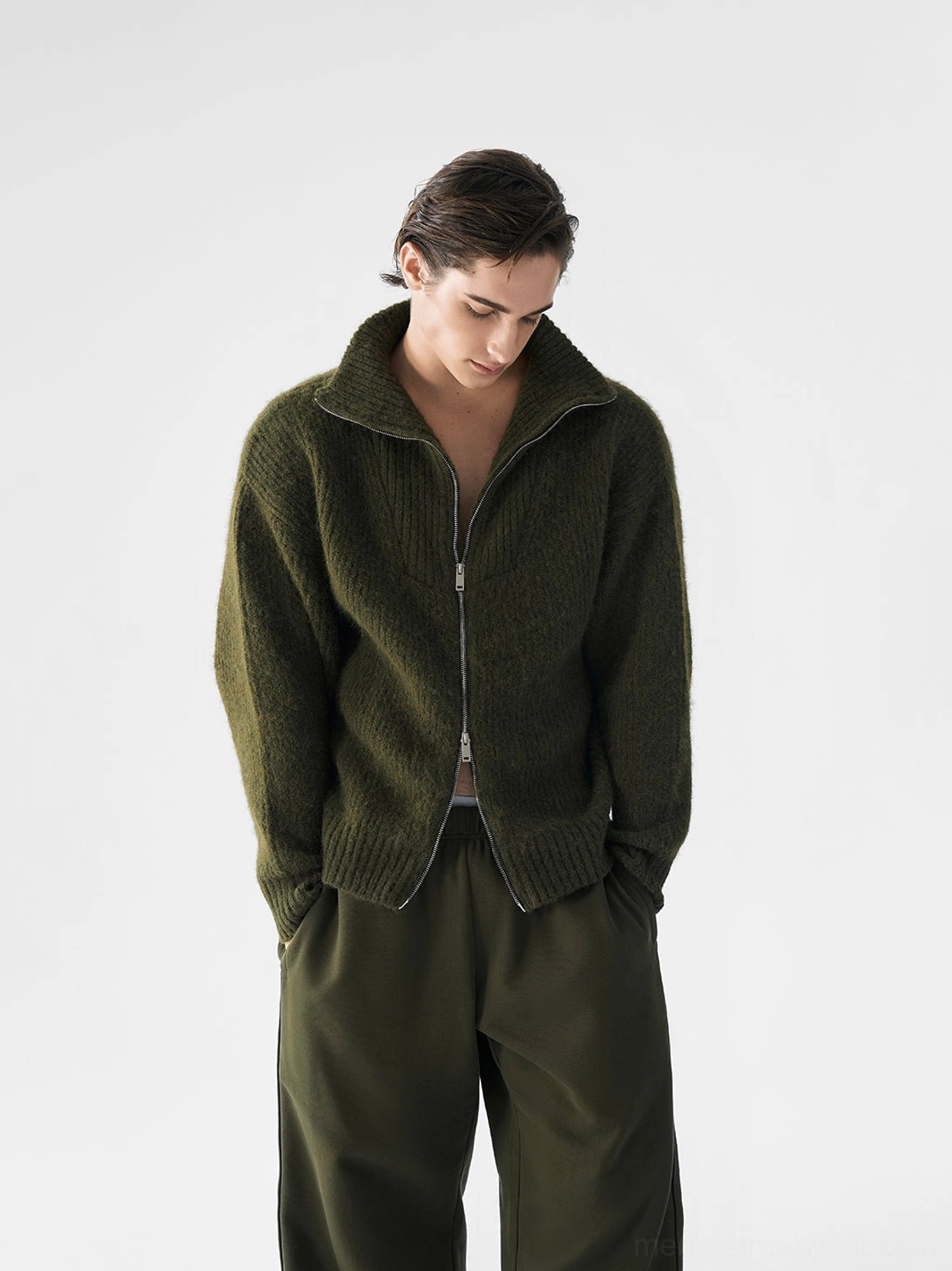 Dark olive green relaxed ribbed two-way zip knit sweater for men shown in front three-quarter view with high fold-down collar