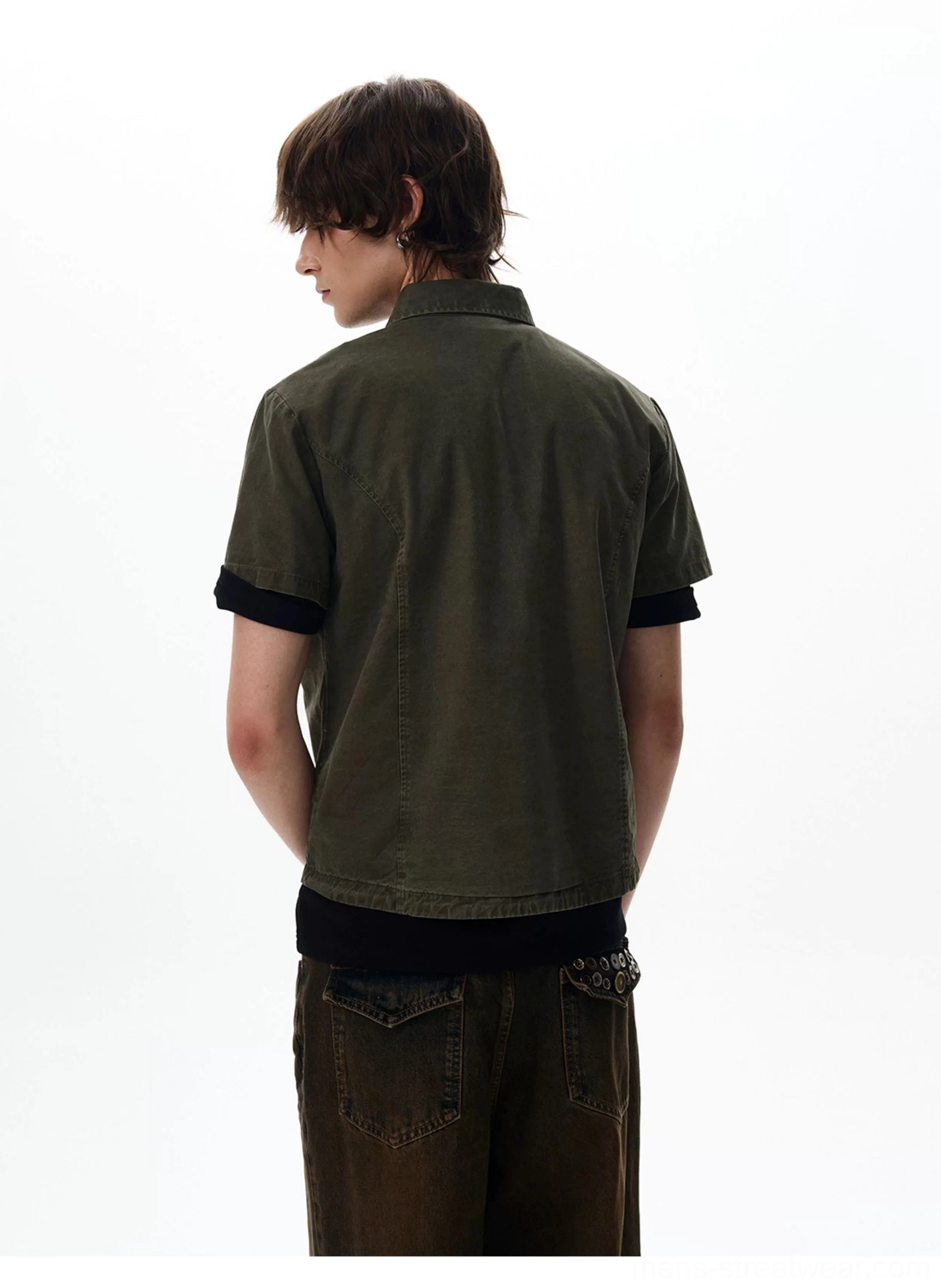 Rear view of minimalist dark olive green short sleeve utility shirt with clean back panel
