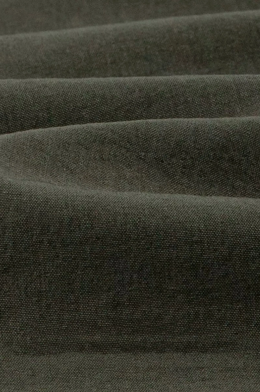 Close-up of dark olive matte woven fabric used for minimalist quick-dry tech shorts
