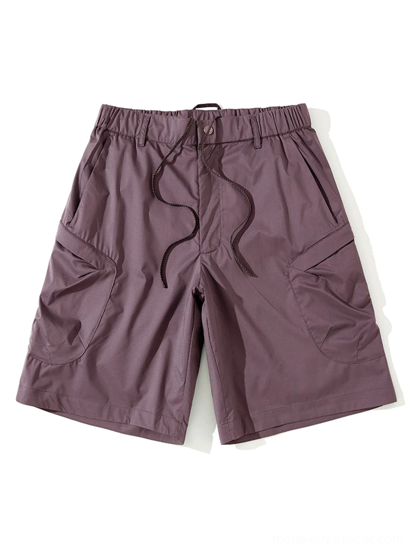 Dark red purple-toned men's cargo shorts displayed flat with a drawstring waist, wide legs, and dual large side pockets